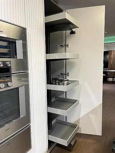 Hochschrankzeile ohne Geräte. Fronten und Wangen mit vertikaler Rippenoptik. Schrank mit integriertem Arbeitsbereich inkl. Beleuchtung.