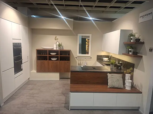 Moderne, elegante L-Küche in mattem Kristallweiß mit hochwertiger Geräteaustattung und Nischenverkleidung in Nussbaum