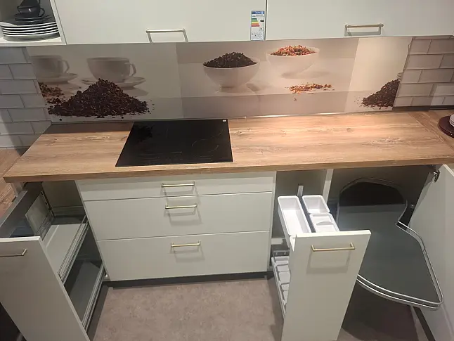 Elegante L-Küche in Weiß matt mit warmen Holz-Akzenten, inklusive Highboard-Elementen und gemütlichem Sitzbereich