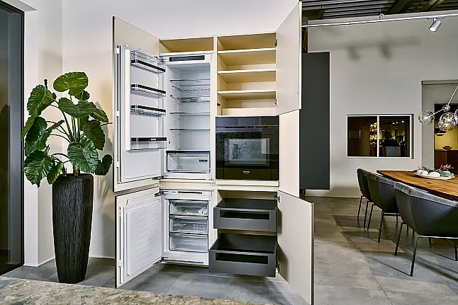 Koje 11 KL: Beige greeploze keuken met vitrinekasten en keramisch werkblad