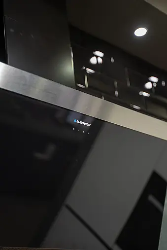 Häcker concept130 grifflose Küche in Kristallweiß – L-Form mit Riffelglas-Vitrinen, Miele &amp; AEG Induktion | Ausstellungsküche
