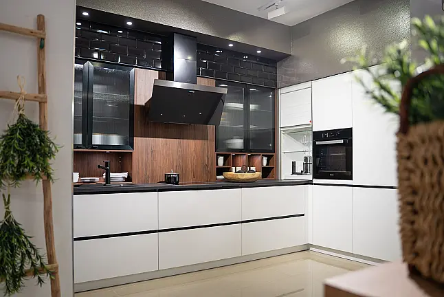 Häcker concept130 grifflose Küche in Kristallweiß – L-Form mit Riffelglas-Vitrinen, Miele &amp; AEG Induktion | Ausstellungsküche