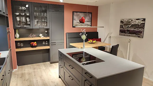 Moderner Landhausstil mit dunkler Front und gemütlicher Sitzmöglichkeit