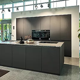 Koje 111 KL: Schwarze grifflose Küche mit Kücheninsel und Granit Arbeitsplatte