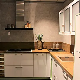 Gemütliche L-Küche mit extra Geräte-Hochschrank für den Kühlschrank in moderner Kombination: Krsitallweiß matt, mit Massiver Steinplatte sowie Farbakzenten in Pastellgrün