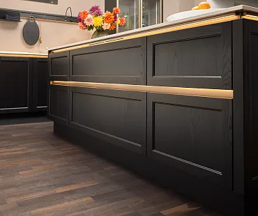 Schwarze Kücheninsel mit grifflosen Rahmenfronten